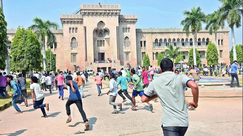 Osmania University students run for shelter, as mild tension broke out in the campus after students took out a rally in protest of the death of a student in the campus.(Photo: DC)