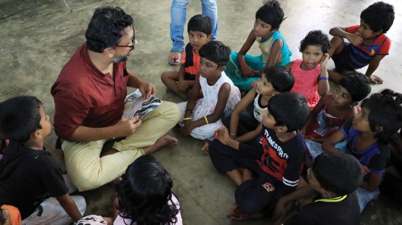 Manu Jose with kids in a relief camp