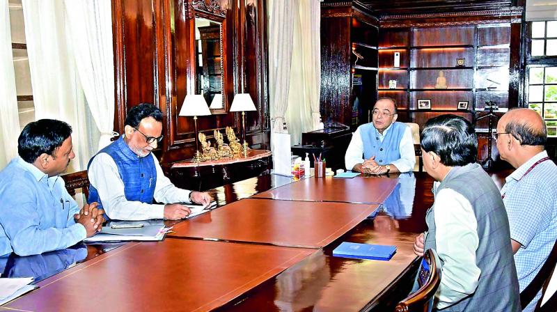 Union finance minister Arun Jaitley is seen along with Hasmukh Adhia in the office on Thursday. Mr Jaitley returned after nearly three month of rest.