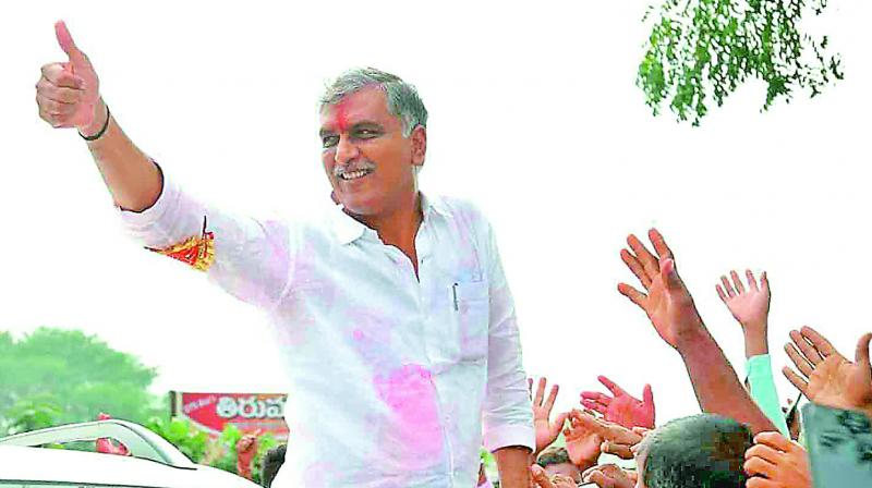 Harish Rao greets his followers with a thumbs-up after his victory in the Siddipet constituency. 	 DC