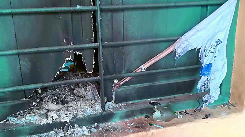 The window of the railway ticket counter gets burnt partially. (Photo: DC)
