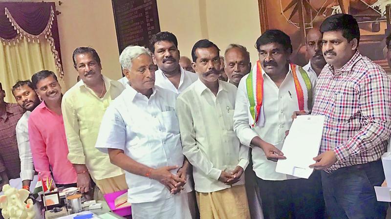 DCC president Panabaka Krishnaiah submitting a representation to collector R. Muthyala Raju urging release of water in Nellore on Tuesday. (Photo: DC)