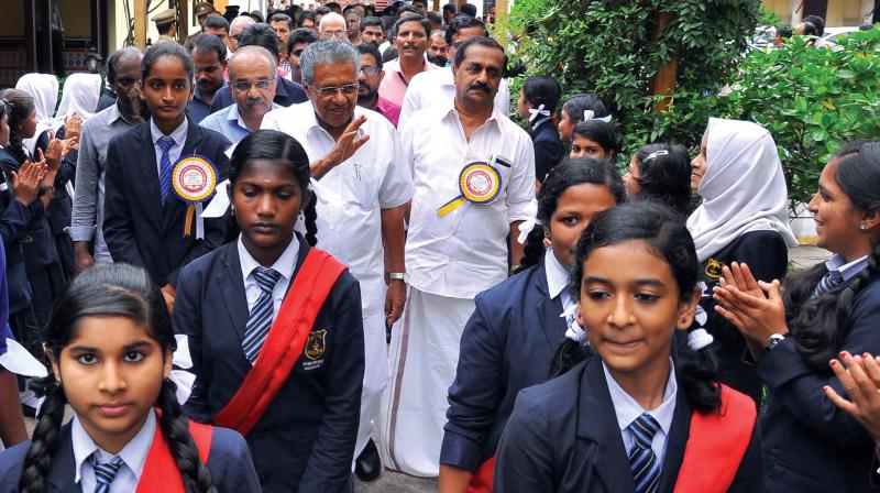 Chief Minister Pinarayi Vijayan greets the students during the  inauguration of a new building at Nadakkavu Government Girls HSS in Kozhikode on Saturday. Kozhikode North MLA A Pradeep Kumar and Mayor Thottathil Raveendran are among others seen.