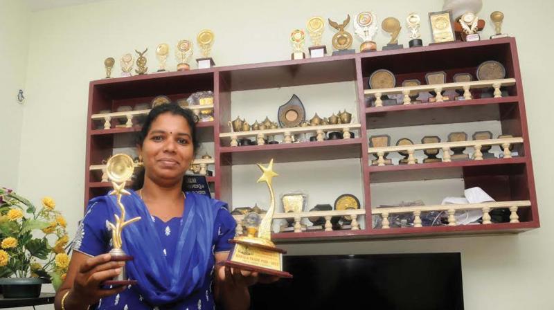 Bindu holds trophies she won for entrepreneurship under the banner of Kudumbashree. (Photo: DC)