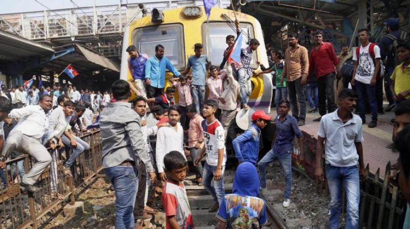 Dalit groups protesting at Thane railway station during the Maharashtra Bandh on Wednesday following clashes between two groups in Bhima Koregaon near Pune, in Mumbai. (Photo: PTI)