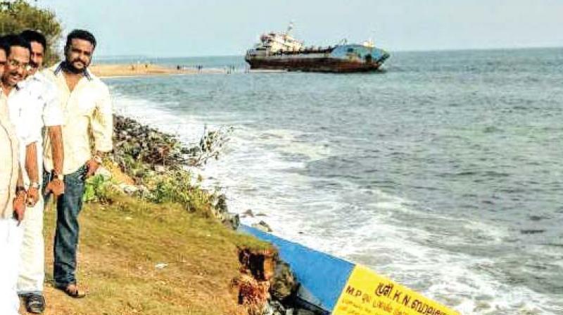 The coastline at Mundakkal papanasam with beached dredger ship Hansita in the background.