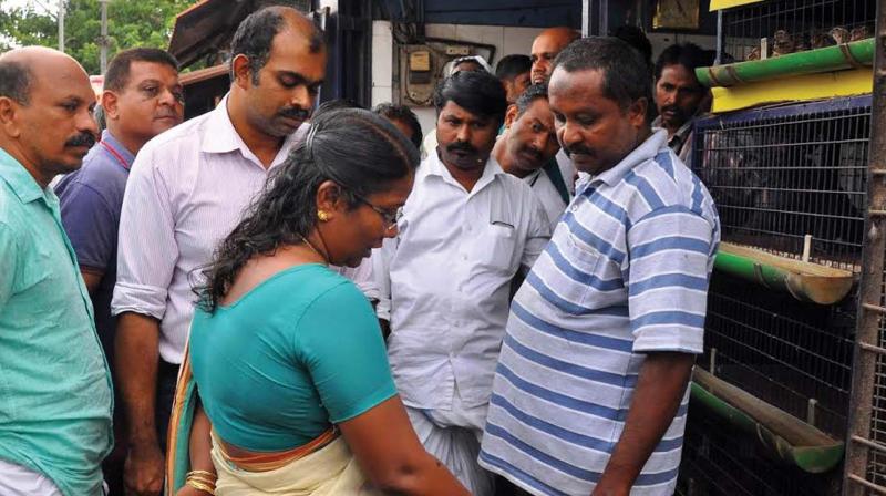 Additional Tehsildar Anitha Kumari, Kozhikode Corporation Health Officer Dr R.A. Gopakumar among other officials inspect a chicken stall in Francis Road on Friday. (Photo: DC)