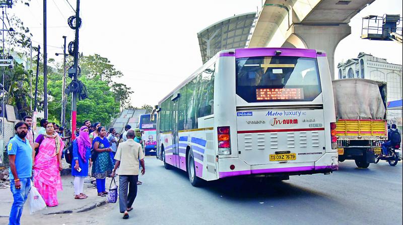 With no bus shelter in place, people are forced to stand on the road to board buses at Lakdikapul. (Photo: DC)