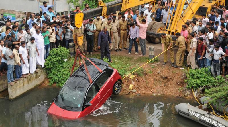 Fire Force personnel fish out the car that fell into the canal below the Thykodam bridge near Vytilla on Friday. (Photo: ARUN CHANDRABOSE)