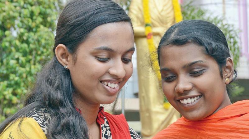 Students of Velammal school, Mogappair check their results in their mobile phones on Friday.