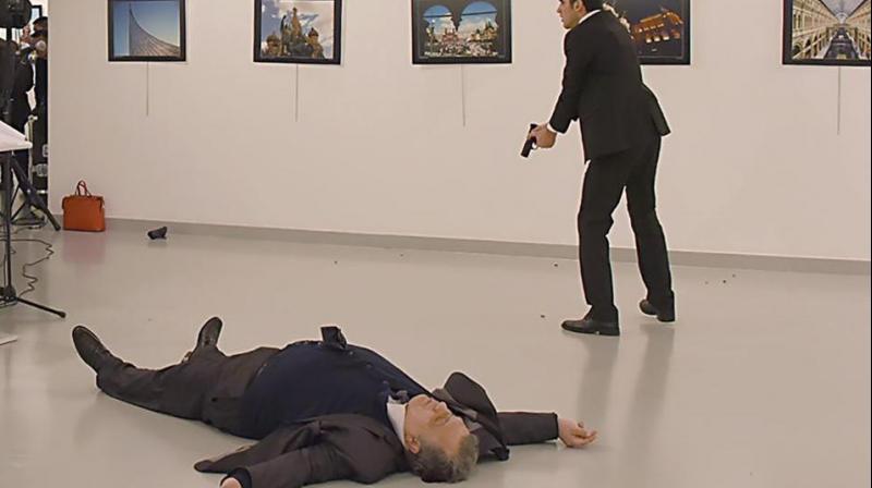 This picture taken on December 19 shows Andrey Karlov, the Russian ambassador to Ankara, lying on the floor after being shot by a gunman during an attack during a public event in Ankara. (Photo: AFP)
