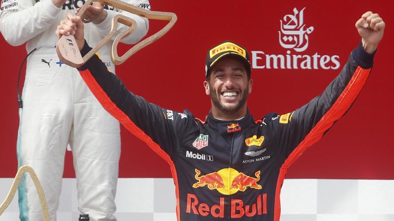 Daniel Ricciardo of Australia celebrates on the podium of the Austrian Formula One Grand Prix. (Photo:AP)