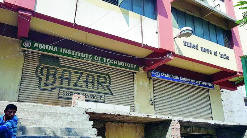 Six of the nine coaching institutions work from this UNI building situated at AC Guards. There were two locked and shuttered doors side by side, indicate remnants of two institutions with signboards indicating that one was the Amina Institute of Technology and the other the Symbiosis Group of Institutions.