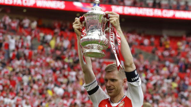 Mertesacker, now a three-time FA Cup winner, repaid the faith in spades as he threw his body into the line of fire time and again to keep Chelsea at bay.(Photo: AFP)