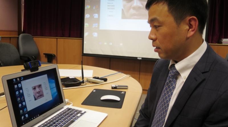 Professor Cheung Yiu-ming demonstrates using the worlds first â€œlip motion passwordâ€technology, which can provide double security in identity authentication.