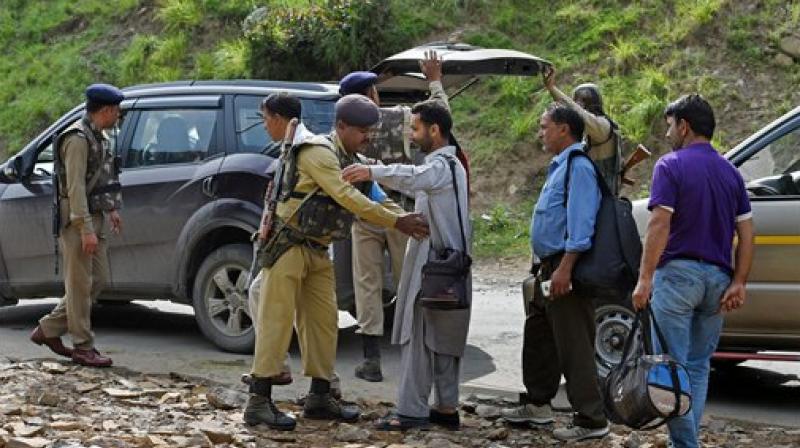 Security personnel frisking the yatris and locals before they head towards the holy cave shrine following the militant attack on a bus in which seven pilgrims were killed and 19 others injured, at Nuwun base Camp in South Kashmir on Monday. (Photo: PTI)