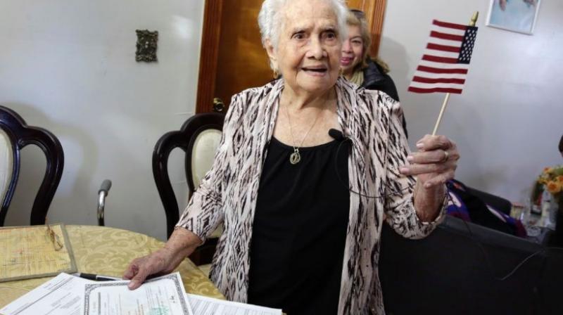 America Maria Hernandez, 99, holds an American flag after being administered the Naturalization Oath of Allegiance in the Queens borough of New York. (Photo: AP)