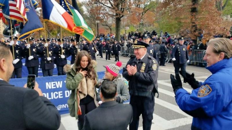 The New York Police Department says an officer who was shot on duty last year proposed to his girlfriend at Thursdays parade. (Photo: Twitter/ @NYPDnews)