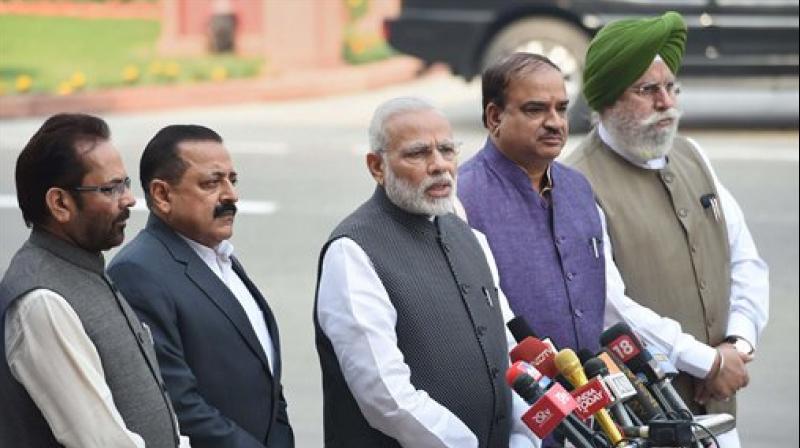 Prime Minister Narendra Modi, flanked by Parliamentary Affairs Minister Ananth Kumar and MoSes Mukhtar Abbas Naqvi, Jitendra Singh and SS Ahluwalia. (Photo: PTI)