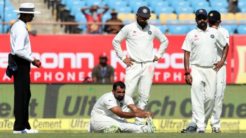 Mohammed Shami, after bowling the first ball of the 61st over, went to his bowling mark holding his thigh.
