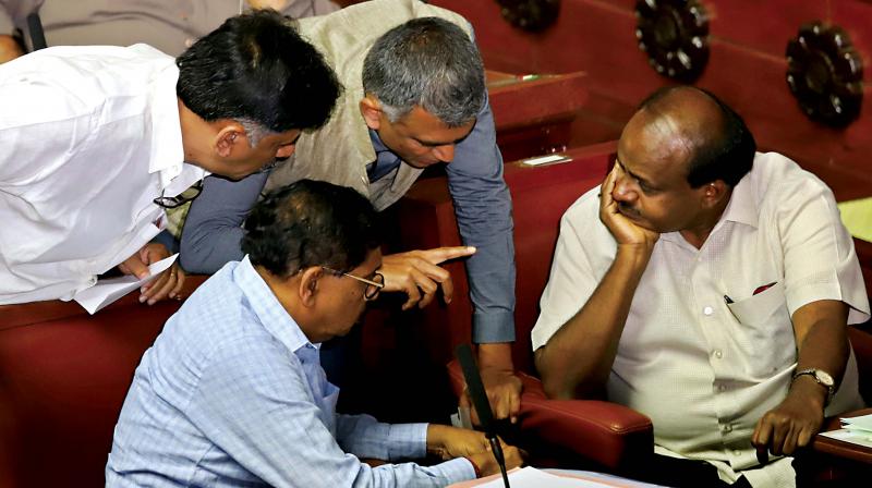 Chief Minister H.D. Kumaraswamy in discussion with DyCM Dr G. Parameshwar and Ministers Krishna Byre Gowda and D.K. Shivakumar during Assembly session at Vidhana Soudha in Bengaluru on Monday (Image DC)