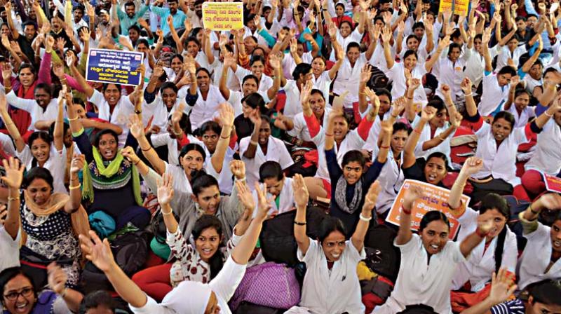 Members of the Karnataka State Health and Medical Education Department Contract Employees Association staged a protest to fulfill their various demands at Freedom Park, in Bengaluru on Monday (Image DC)
