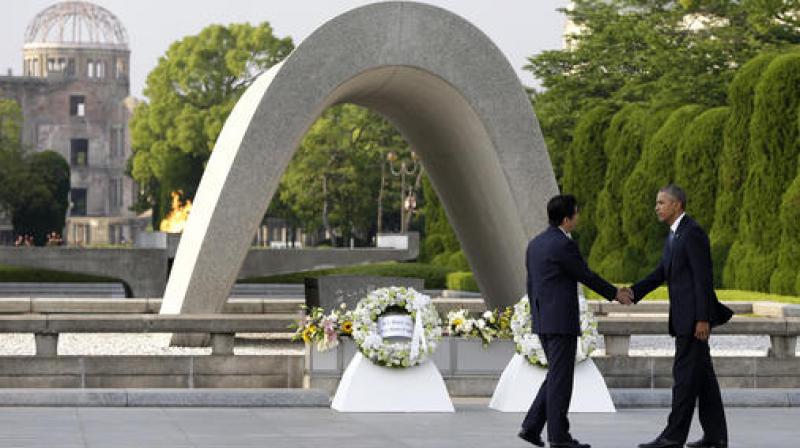 President Barack Obama, right, shakes hands with Japanese Prime Minister Shinzo Abe at Hiroshima Peace Memorial Park in Hiroshima. (Photo: AP)