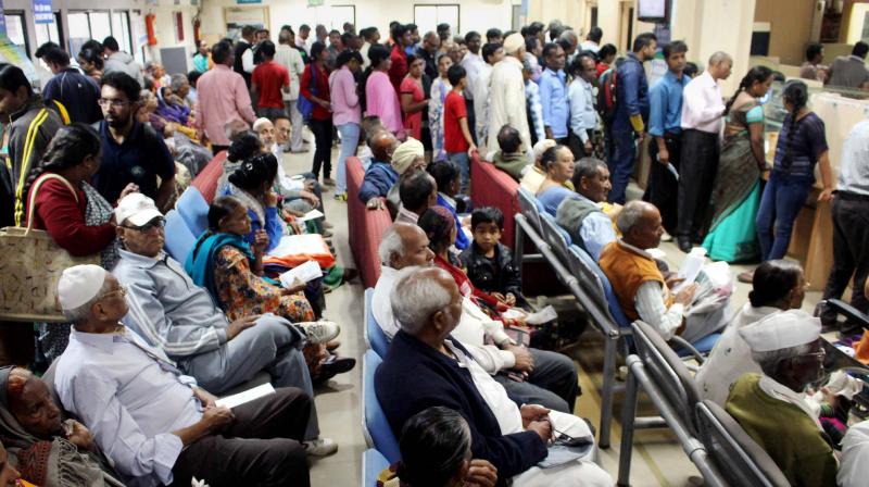 People queue up inside a bank to withdraw cash in Bhopal. (Photo: PTI)