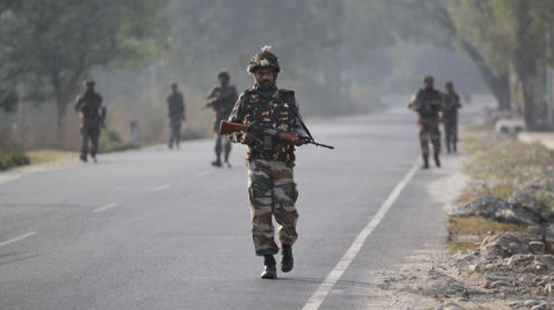 Soldiers patrol a highway outside an army base in Nagrota, about 15 kilometers from Jammu. (Photo: PTI)