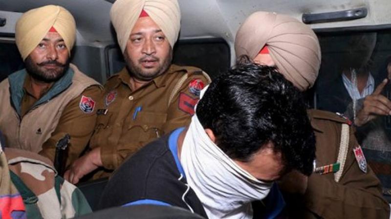 Police take an accused to the court at Nabha on Wednesday in connection with the Nabha jail break case. (Photo: PTI)