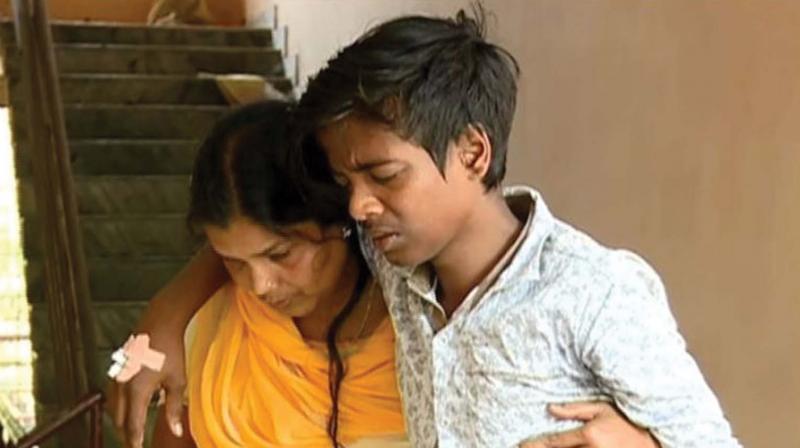 Renju Krishnan with his mother at the taluk  hospital. 	(File pic)