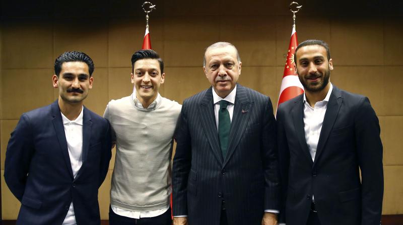 The photos, which show Mesut Ozil and Ilkay Gundogan standing next to the Turkish president Tayyip Erdogan unleashed a storm of criticism from lawmakers across Germanys political spectrum and the DFB football federation, all of whom argued that Erdogan does not sufficiently respect German values. (Photo: AP)
