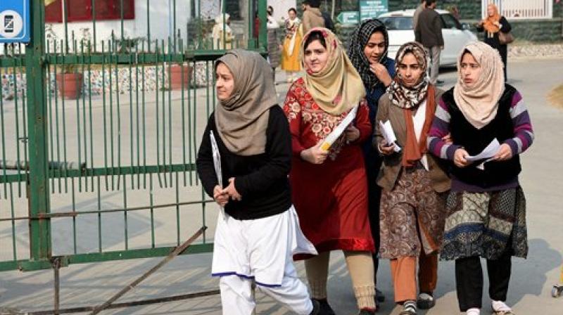 Students leave after appearing in the Annual board examination in Srinagar on Monday. (Photo: PTI)