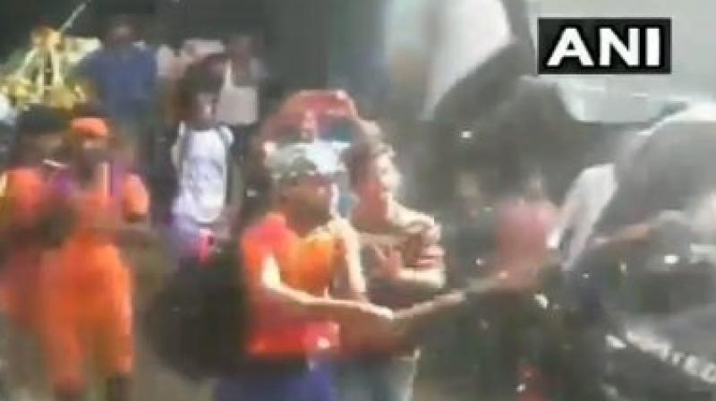 Kanwariyas were filmed attacking a police van on a busy road, and also indulged in an altercation with the locals in Uttar Pradeshs Bulandshahr district. (Photo: ANI/Twitter)