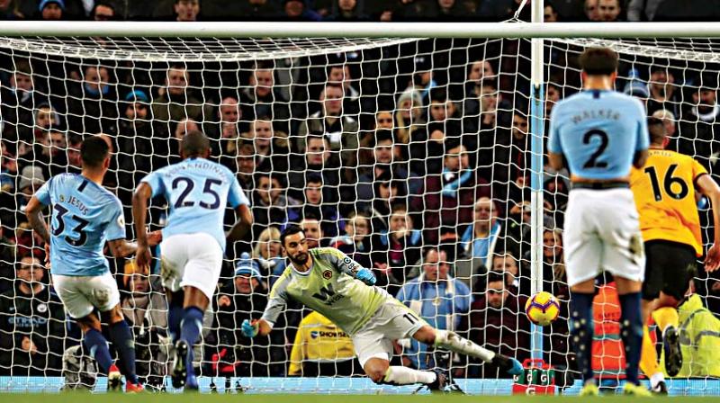 Manchester Citys Gabriel Jesus (left) scores against Wolverhampton Wanderers in their English Premier League match at the Etihad Stadium in Manchester on Monday. The hosts won 3-0. (Photo: AP)