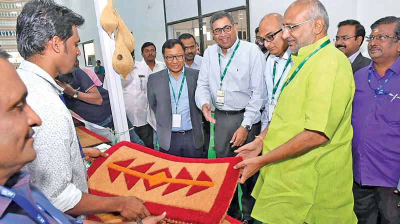 CP Radhakrishnan of Coir Board takes a look at a stall at Coconut festival 2018 in Coimbatore on Saturday. (Photo: DC)