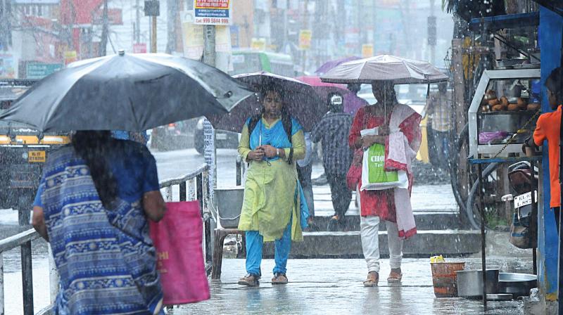 People move through the streets of Kochi amidst monsoon rains. ARUNCHANDRA BOSE