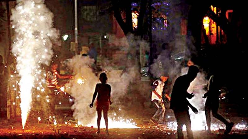 File photo of people bursting fire crackers during Deepavali