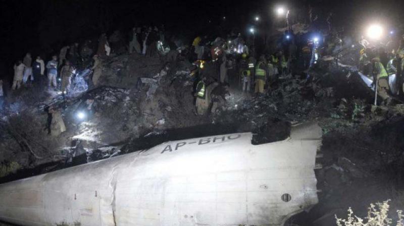 Soldiers and volunteers scour the wreckage of the crashed PIA plane in Abbottabad district. (Photo: AFP/File)