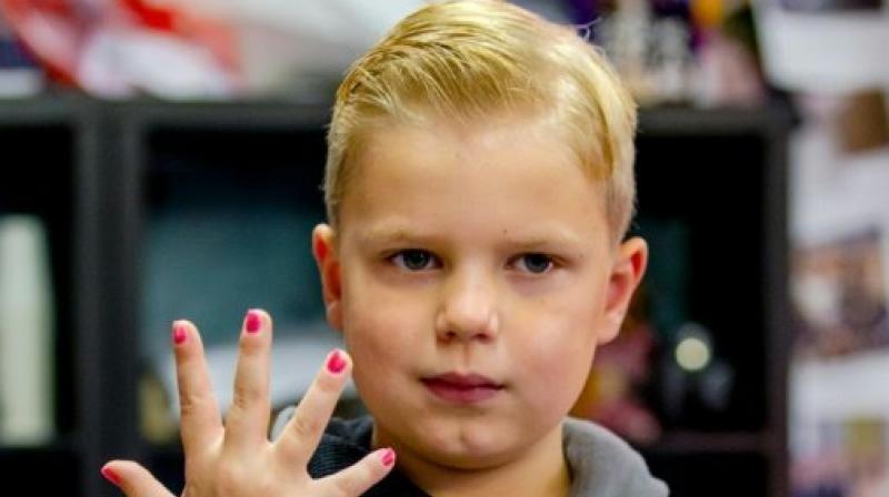 Tijn, a 6-year-old boy, shows his painted nails as he raises money during the \Serious Request\ radio program at the House of Glass in Breda, The Netherlands. (Photo: AFP)