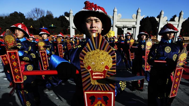 Performers dressed as a Qing Dynasty servants participate in the ancient Qing Dynasty ceremony in which emperors prayed for good harvest and fortune at a temple fair in Ditan Park during the first day of the Chinese Lunar New Year in Beijing, Monday, Feb. 8, 2016. (Photo: AP)