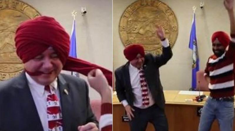A video posted on Facebook shows Whitehorse Mayor Dan Curtis wearing a turban and doing the bhangra dance with one of the residents. (Credit: Facebook)