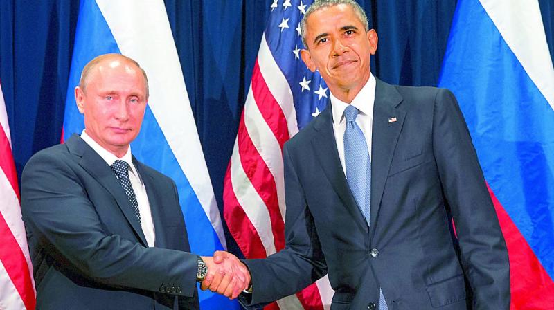 U.S. President Barack Obama, right, and Russias President President Vladimir Putin pose for members of the media before a bilateral meeting at the United Nations headquarters. President Barack Obama is promising that the U.S. will retaliate against Russia for its suspected meddling in Americas election process, an accusation the Kremlin has vehemently denied.(Photo: AP)