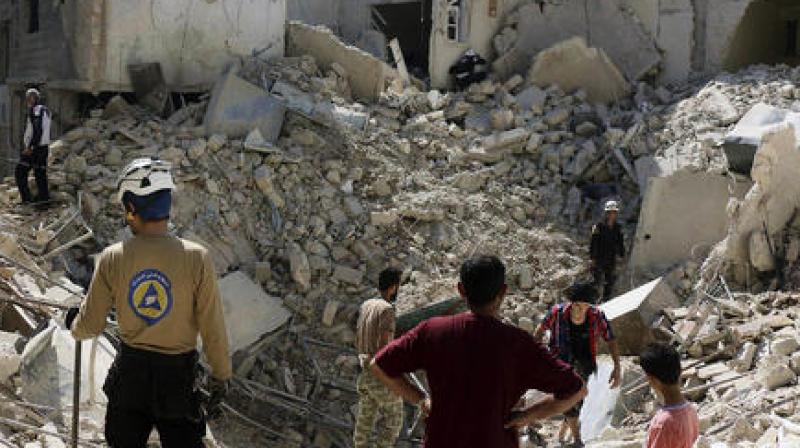 Syrian Civil Defense workers search through the rubble in rebel-held eastern Aleppo. (Photo: AP)