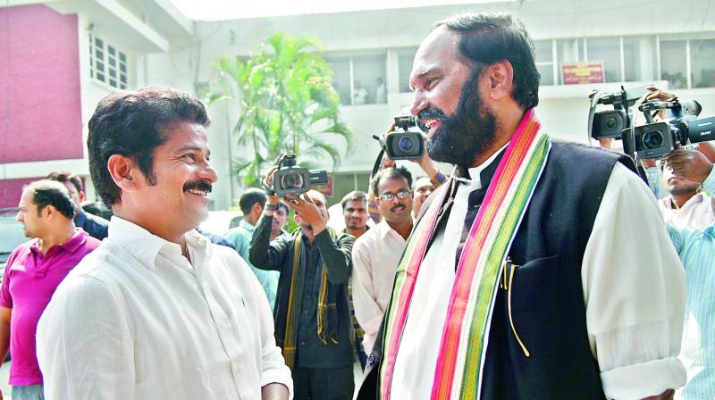 TPCC president Uttam Kumar Reddy exchanges pleasantries with TS TD working president A. Revanth Reddy at the Assembly in Hyderabad on Thursday. 	(Photo: DC)