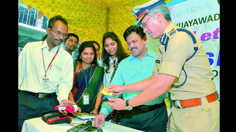 Police commissioner D. Gautam Sawang swipes a card to mark the inauguration of cashless transactions in the police department in Vijayawada on Thursday. (Photo: DC)