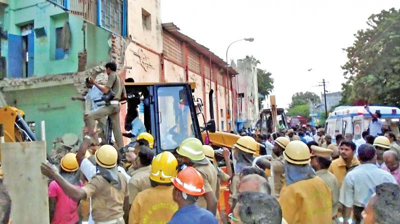 Rescue workers clear the site of a bus depot roof collapse in Porayar of Nagapattinam district on Friday. (Photo: PTI)