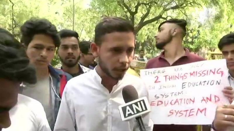 Raising slogan we want justice, the protesting students said, either there should re-examinations of all subjects or else of neither. (Photo: Twitter | ANI)