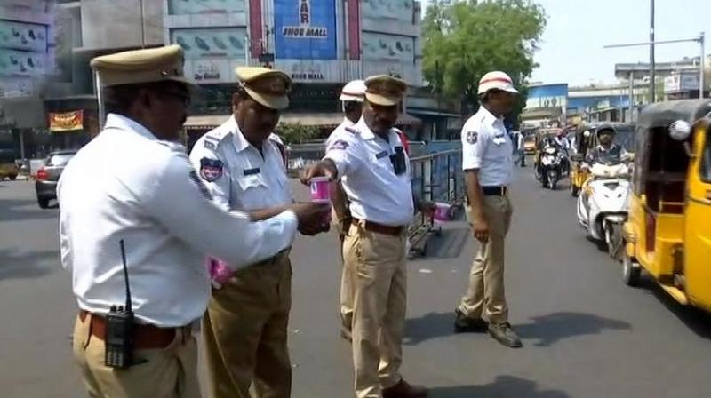 Traffic Police is distributing butter milk packets among its personnel deployed in the city to counter rise in temperature during summer. (Photo: ANI | Twitter)