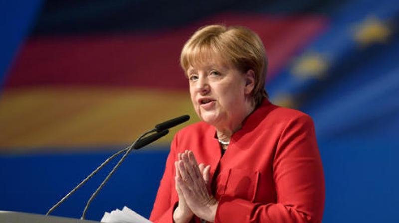 German Chancellor and Chairwomen of the CDU, Angela Merkel, gestures during her speech as part of a general party conference of the Christian Democratic Union in Essen. (Photo: AP)